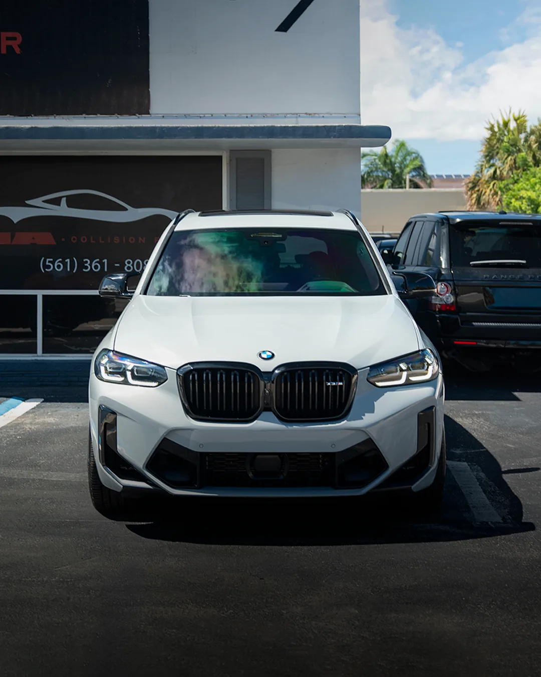 BMW X3 M in front of the HA Collision Repair building in Boca Raton