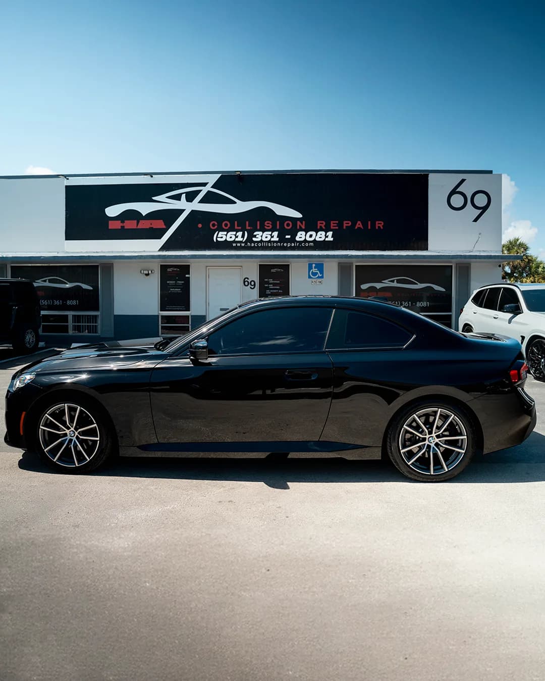 BMW 2 Series outside the HA Collision Repair shop in Boca Raton